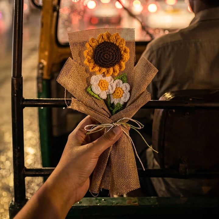 Hand holding a decorative crochet sunflower daisy bouquet 