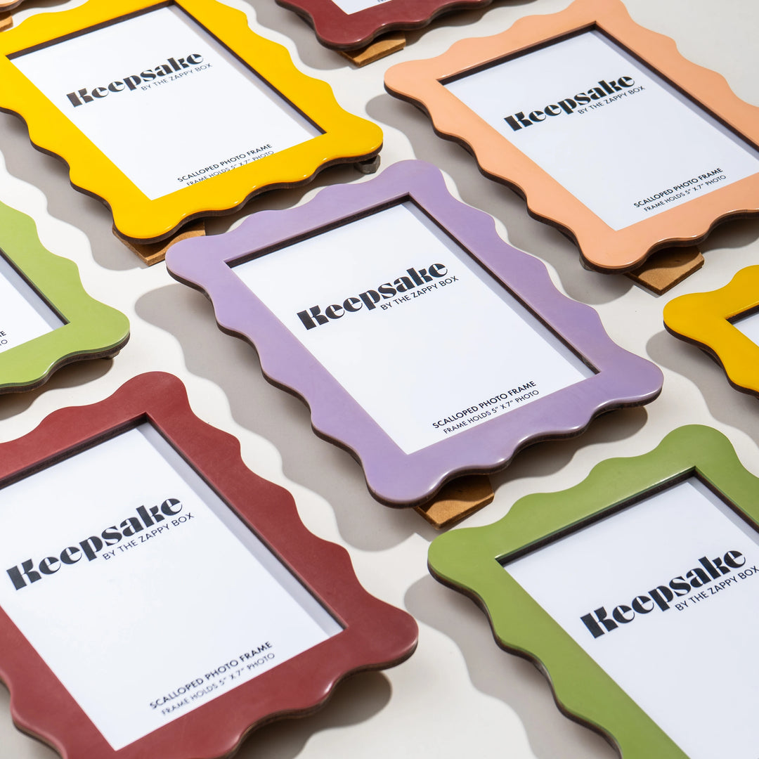 Flat lay of Scalloped Aesthetic Keepsake Memory Frames in multiple color variants, including Pastel Green, Pastel Violet, Pastel Yellow, and Maroon, arranged together showcasing the full collection